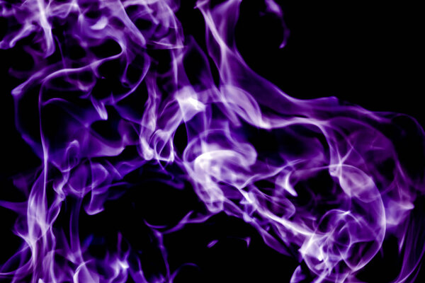 Beautiful violet tongues of flame, fire dance, background texture
