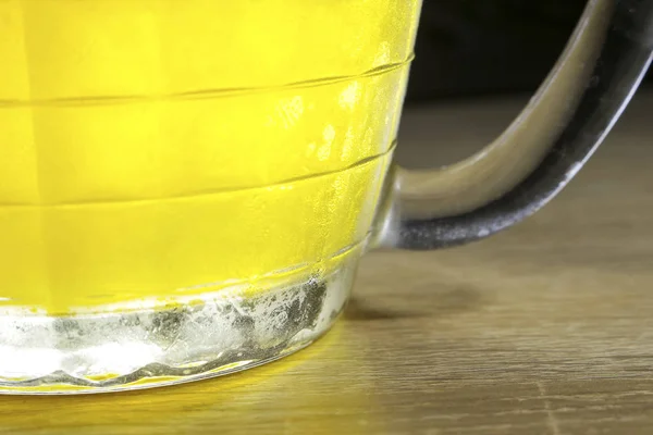 big glass of golden beer close-up