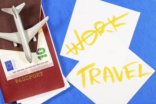a toy airplane, money and a passport, preparation for travel, not work