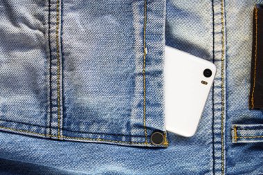 mavi kot pantolon beyaz smartphone yatıyor