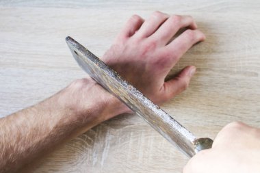 to cut off a hand with an ax clipart