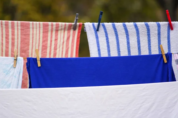 washed laundry dries on a rope in the yard