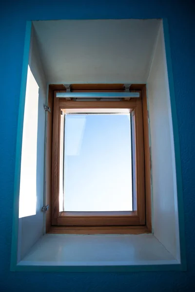 view of the blue sunny sky outside the window