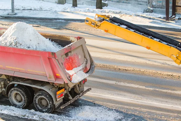 snow-cleaning machinery cleans the street