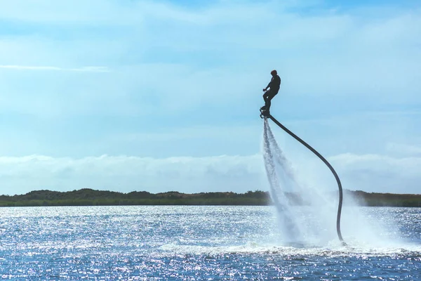 男に乗っている Flyboard 晴れた日にトーンダウン — ストック写真