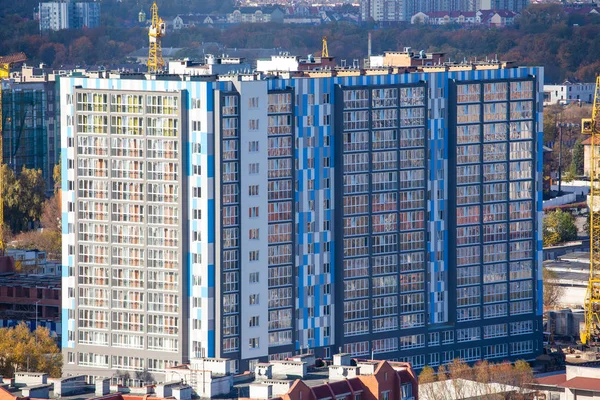 a huge typical apartment building in the form of a box