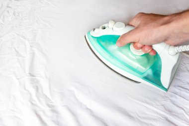 adamın elinde demir darbeler beyaz buruşturulmuş kumaş