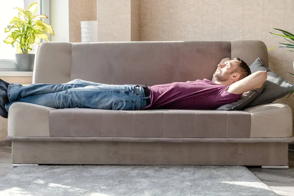 Young Man Resting Lying Sofa Bright Room — Stock Photo, Image