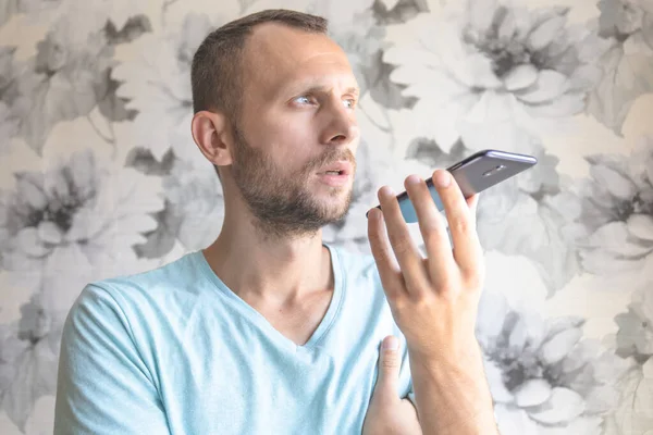 man writes voice message on smartphone