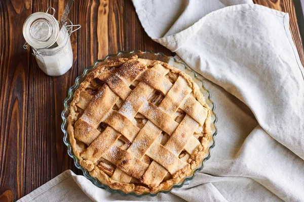 Homemade apple pie on the brown wooden table. Apple tart with lattice top overhead view. Rustic style — Stock Photo, Image