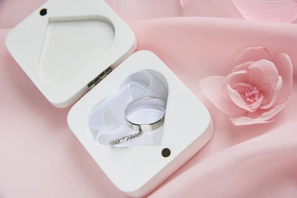 Anéis de casamento na caixa de madeira especial branca no pano rosa - conteúdo de decoração de casamento — Fotografia de Stock