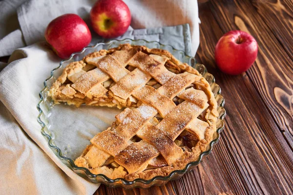 Comida horneada: tarta de manzana servida con manzanas frescas en plato blanco sobre mesa de madera — Foto de Stock