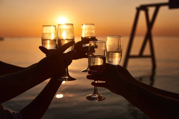 hen party before the wedding. girls relax at the resort. early morning friends drink champagne and meet the dawn on the ocean