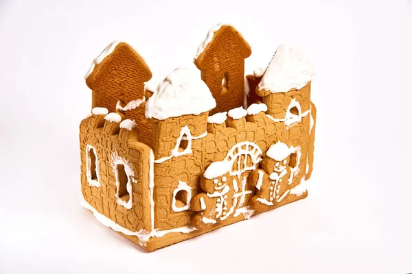 gingerbread house with icing decor on white background. Concept of winter traditional dessert - top view