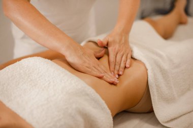 Spa salonundaki kadın için karın masajı terapisi