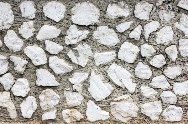 Fehér szabálytalan alakú kő fal építése — Stock Fotó