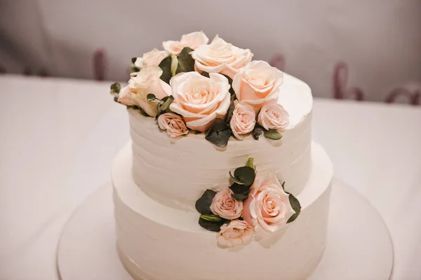 Festive wedding cake with flowers, pink-orange flowers, bunk, beautiful