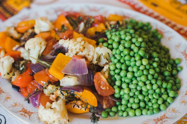 Baked vegetables. Baked vegetables in large pieces on a plate. Vegetarian diet. Close up. Vegetable garnish grill.