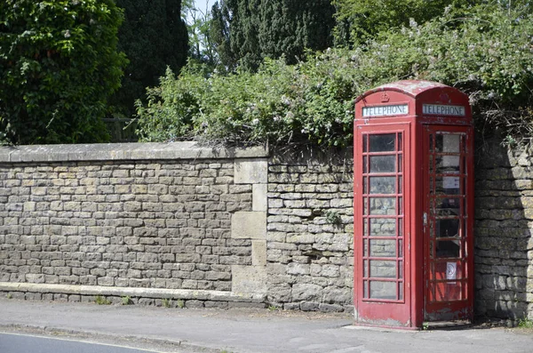 Old red telephone box in the historic village of Lacock, Wiltshire, England