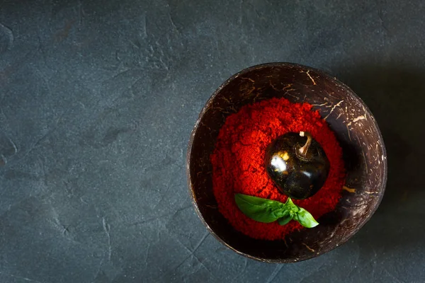 Chili Pepper Powder with basil in bowl on grey background — Stock Photo, Image