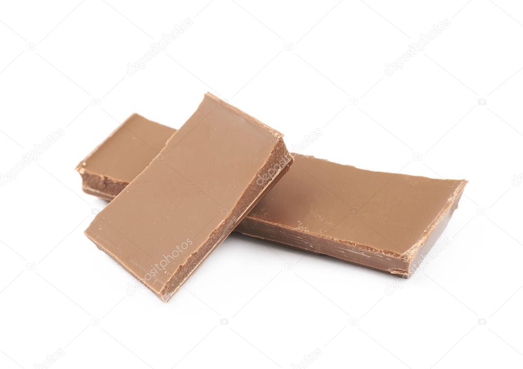 Pile of milk chocolate pieces isolated