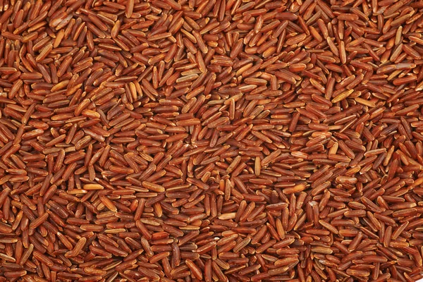 Superfície coberta com o arroz vermelho — Fotografia de Stock