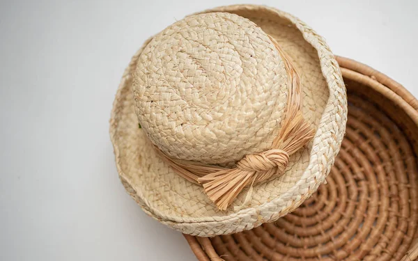 Straw hat on handmade woven basket