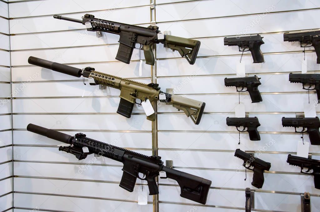 Gun wall rack with rifles and pistol.