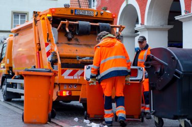 Soest, Germany - December 31, 2018:  Waste collection vehicle with workers in Germany. clipart