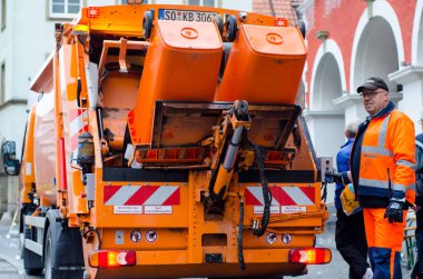 Soest, Germany - December 31, 2018:  Waste collection vehicle with workers in Germany. clipart