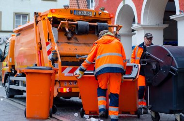 Soest, Germany - December 31, 2018:  Waste collection vehicle with workers in Germany. clipart