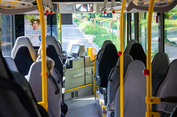 Soest, Germany - August 1, 2019: Inside Mercedes-Benz bus with passenger view from the back