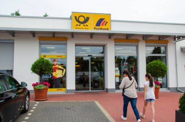 Soest, Germany - July 22, 2019: Deutsche Post and Postbank branch clipart