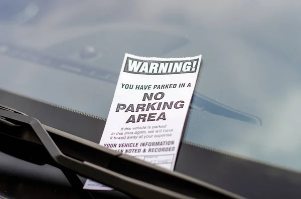 Close-up of parking ticket on car\'s windshield
