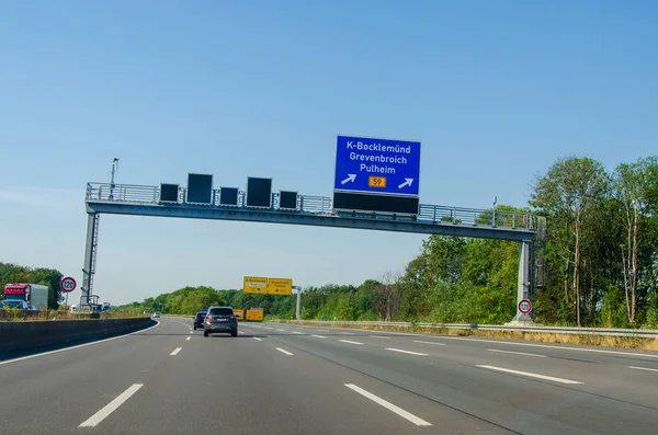 North Rhine-Westphalia, Germany - July 26, 2019: Road traffic on the German Highway (autobahn) A1 with road signs. Cars ride on the German autobahn. — Stock Photo, Image