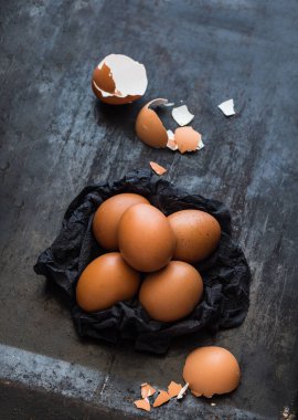 Koyu arka plan üzerinde siyah peçeteye kahverengi yumurta