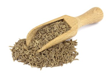 Food ingredients: heap of cumin in a wooden scoop, on white background clipart
