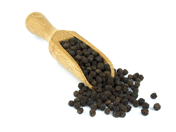 Food ingredients: heap of black pepper in a wooden scoop, on white background