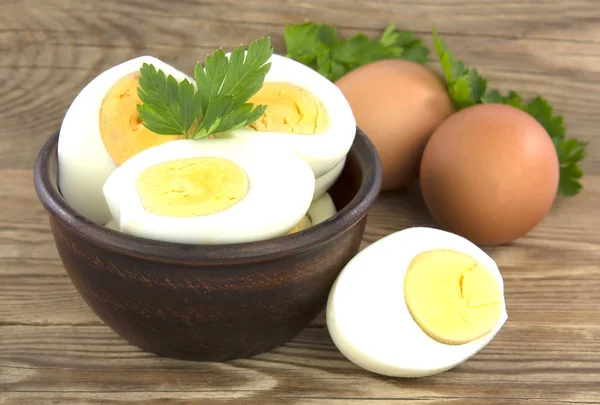 Sliced boiled eggs, with parsley leaves. Cooking a salad with bo