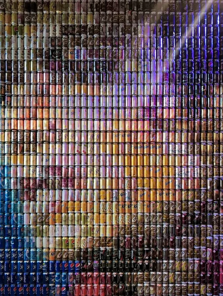 A mosaic of a face made of tin cans