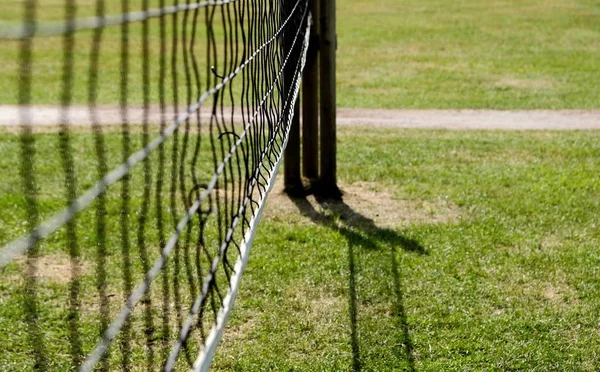 Volleyball net with bicycle on a sunny day