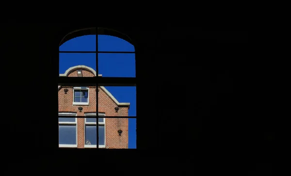 Grandi finestre nella casa sul canale di Amsterdam in una giornata di sole — Foto Stock