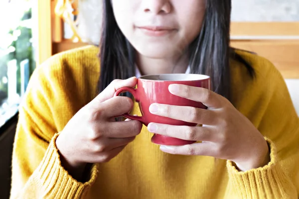 Cute asian woman in the cafe with hot coffee cup