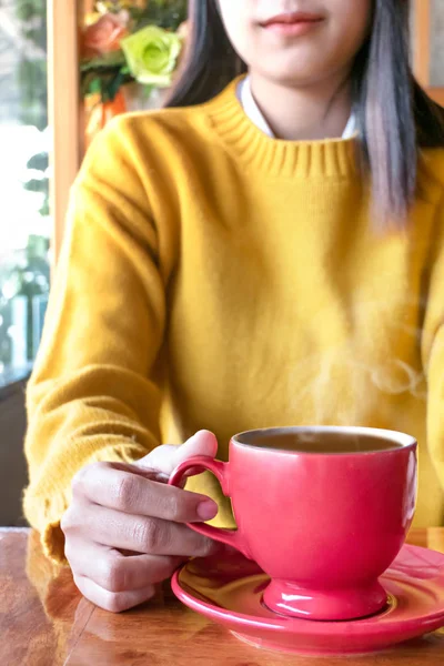 Cute asian woman in the cafe with hot coffee cup