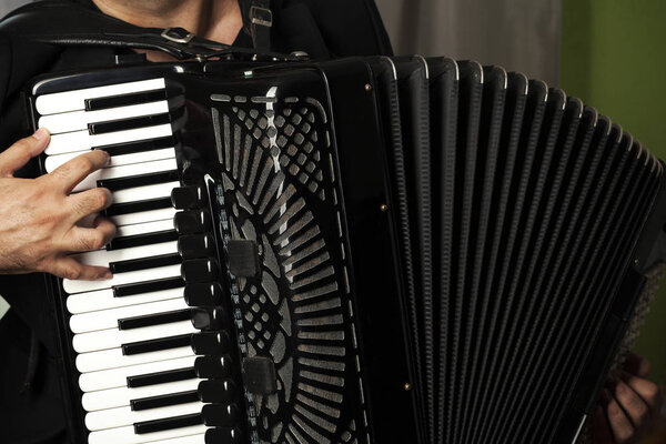 man play the accordion, close up