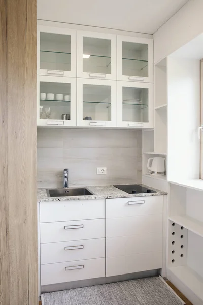 small white kitchen in small apartment