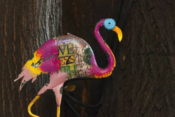 flamingo toy sculpture against tree