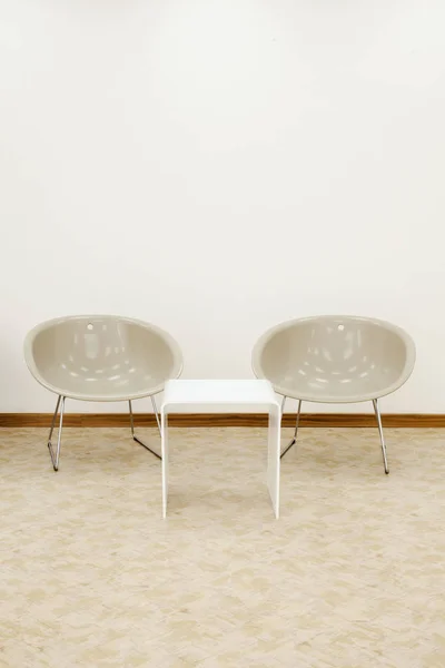 Two beige chairs and white coffee table — Stock Photo, Image