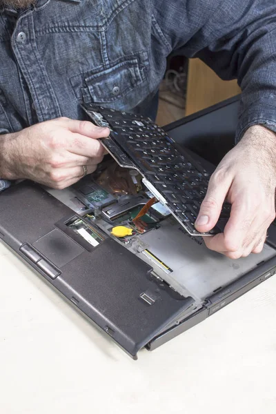 Servis teknisyeni'nın elleri bir laptop kırık bir klavye değişimi.