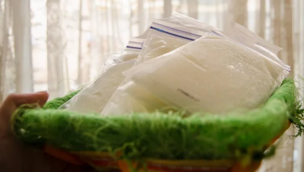 frozen breast milk in storage bags in the basket
